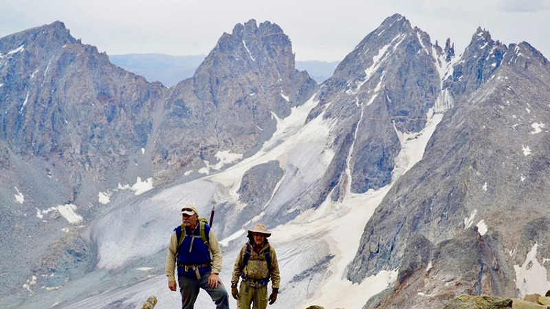 Kilpatrick and friend behind the Grand Tetons